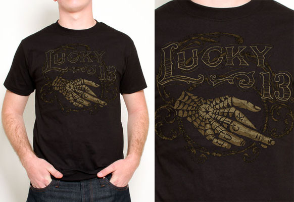 Crossed Artist Series tattooed hand design on a black shirt by Lucky 13 Clothing