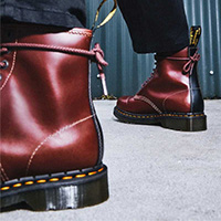 8 Eye Brown & Black Abruzzo Boots by Dr. Martens