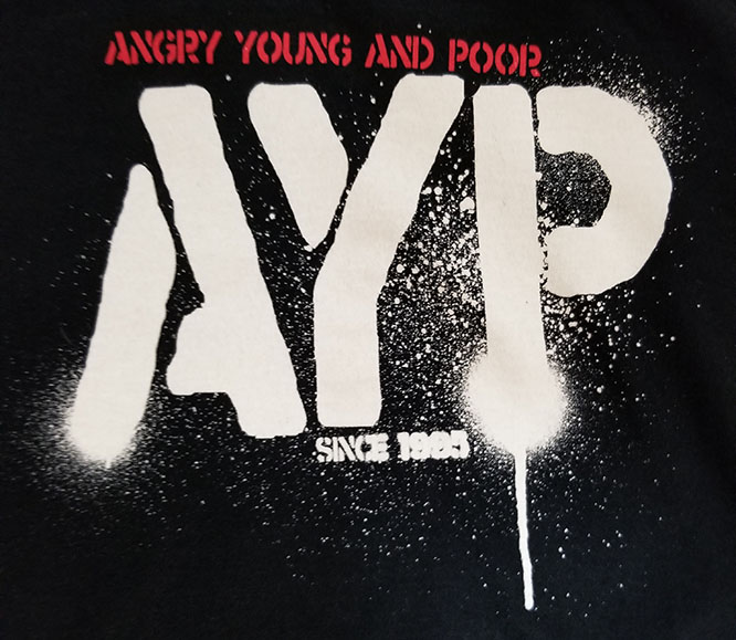Angry Young And Poor- Since 1995 on a black ringspun cotton shirt