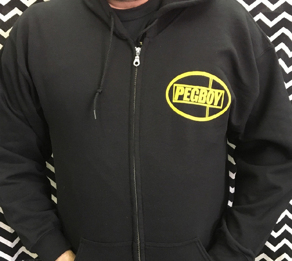Pegboy- Logo on front, Strong Reaction on back on a black zip up hooded sweatshirt